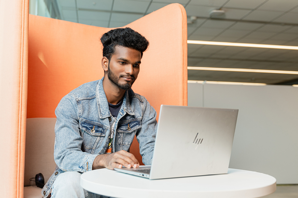 Card image of man working on a laptop