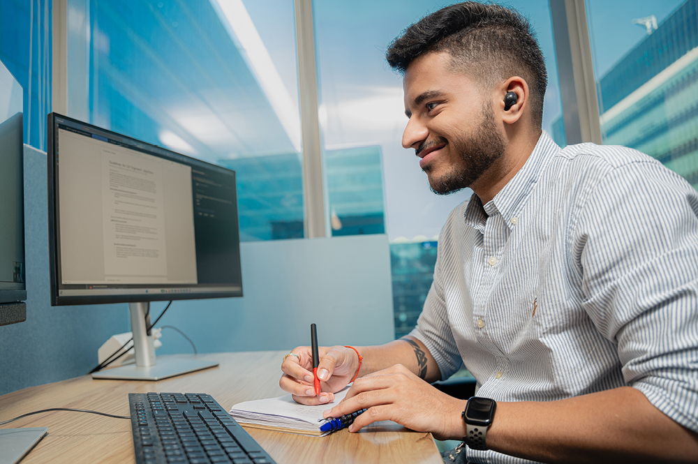 Card image of man working on a laptop